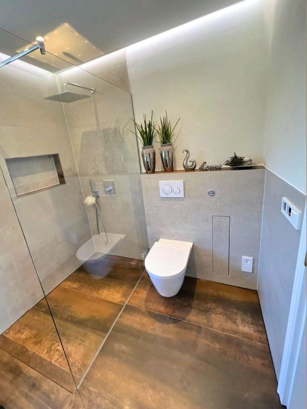 Badezimmer mit Dusche und WC sowie modernen Fliesen nach Renovierung in Ingolstadt von Renovierung & Sanierung ALBAN